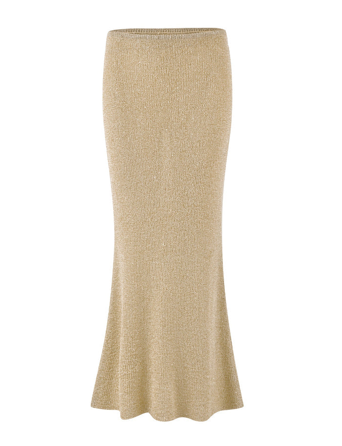 The CONNELL SKIRT - GOLD by TIGERMIST is a beautifully crafted gold maxi skirt with subtle sequin details. It features a high-waisted, form-fitting design that hugs the hips and thighs before elegantly flaring out into a glamorous mermaid-style hem.