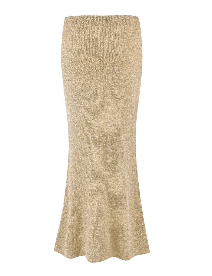 The CONNELL SKIRT - GOLD by TIGERMIST is a glittery gold maxi skirt featuring a fitted waist and a slight flare at the hem. The knit fabrication adds texture, creating a shimmering effect with subtle sequin details. The design is elegant and suitable for formal or festive occasions.