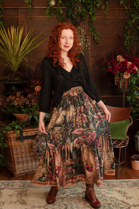 Model wearing a bamboo-viscose maxi-length skirt with Sacred Heart art and hidden affirmations — a soulful, wearable reminder to aim true and take heart - Market of Stars