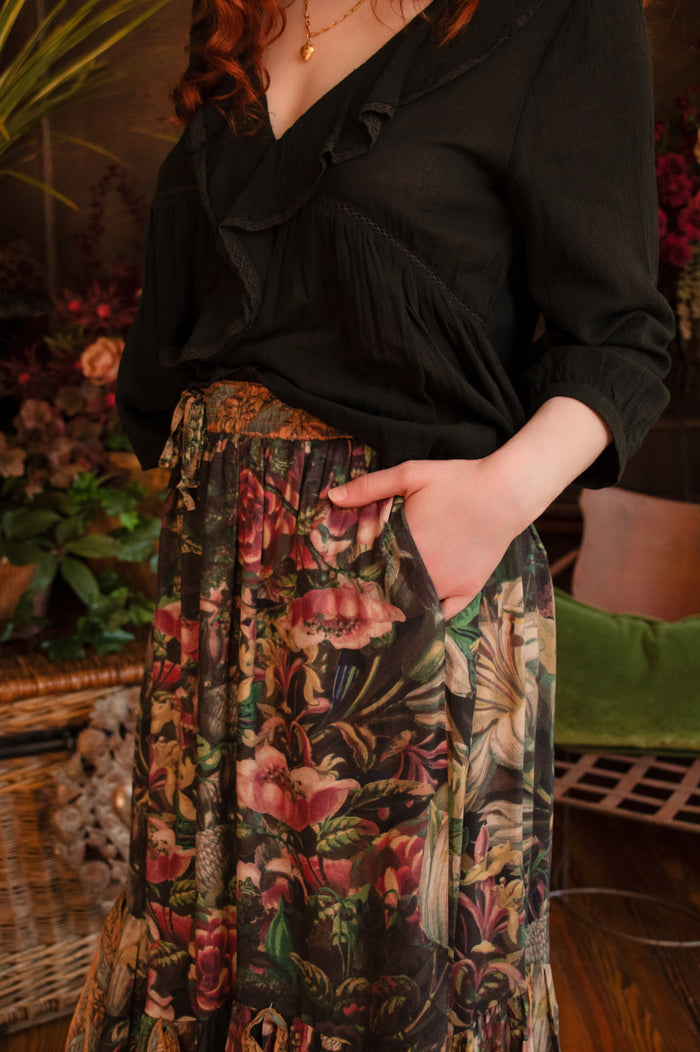 Model wearing a bamboo-viscose maxi-length skirt with Sacred Heart art and hidden affirmations — a soulful, wearable reminder to aim true and take heart - Market of Stars