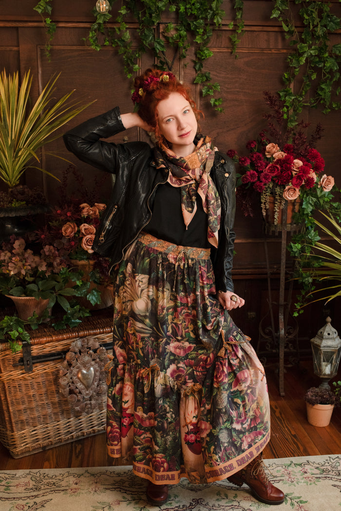 Model wearing a bamboo-viscose maxi-length skirt with Sacred Heart art and hidden affirmations — a soulful, wearable reminder to aim true and take heart - Market of Stars
