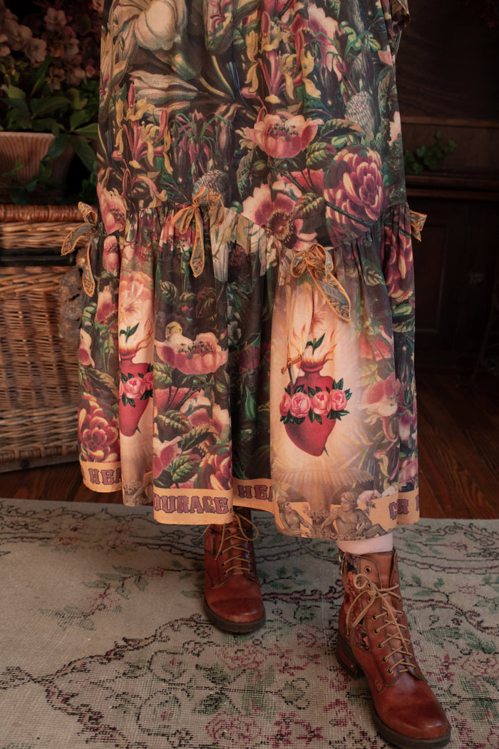 Model wearing a bamboo-viscose maxi-length skirt with Sacred Heart art and hidden affirmations — a soulful, wearable reminder to aim true and take heart - Market of Stars