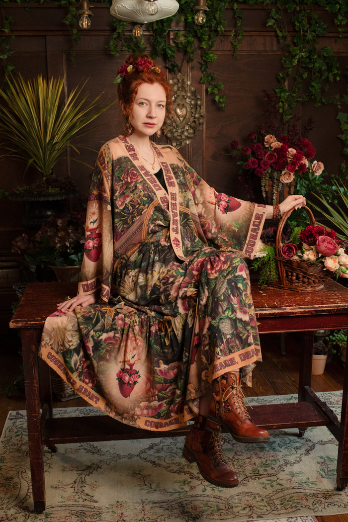 Model wearing a bamboo-viscose maxi-length skirt with Sacred Heart art and hidden affirmations — a soulful, wearable reminder to aim true and take heart - Market of Stars