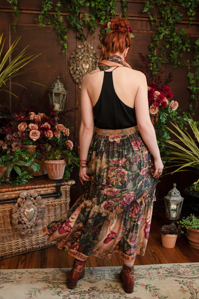 Model wearing a bamboo-viscose maxi-length skirt with Sacred Heart art and hidden affirmations — a soulful, wearable reminder to aim true and take heart - Market of Stars