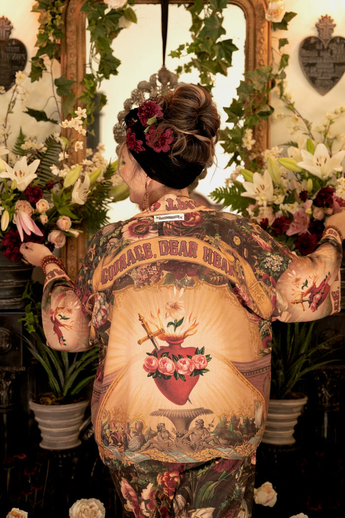 Model wearing Courage Dear Heart Pixie cut Duster featuring Victorian Sacred Heart art and hidden affirmations of courage and love on bamboo-based viscose – Market of Stars.