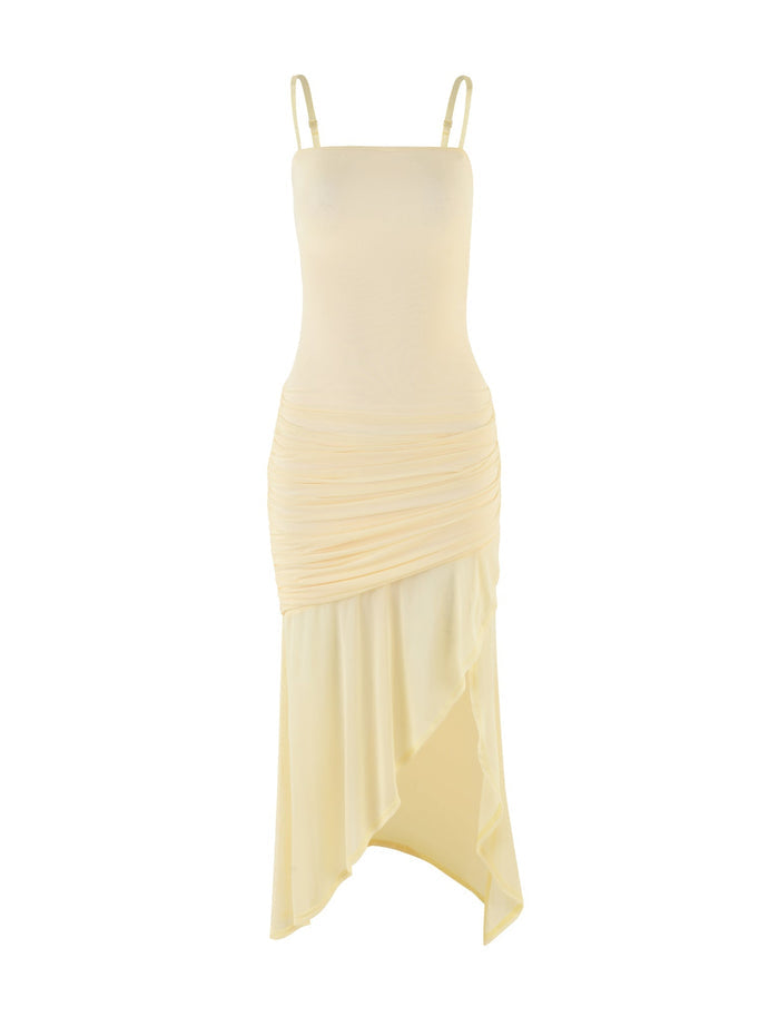 The COVE MIDI DRESS - YELLOW : BUTTER from TIGERMIST is a light yellow sleeveless dress with spaghetti straps and an asymmetrical ruched skirt. It features a fitted bodice that smoothly transitions into a draped, asymmetric hemline.