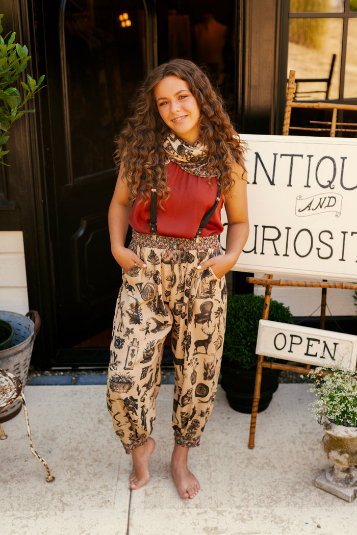 Model wearing relaxed viscose pant with elastic and drawstring waist, inspired by a mysterious Victorian scrapbook. This whimsical print celebrates the wonder hidden in ordinary things — Market of Stars.
