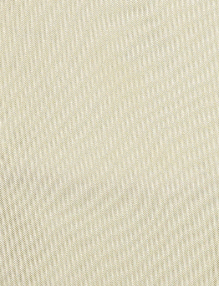 A close-up view of the CYRIL DRESS - YELLOW : LEMON by TIGERMIST reveals a finely woven fabric in a light beige or off-white color. The texture is smooth with a subtle pattern, reminiscent of the elegant material used for its adjustable straps and satin cowl back design.