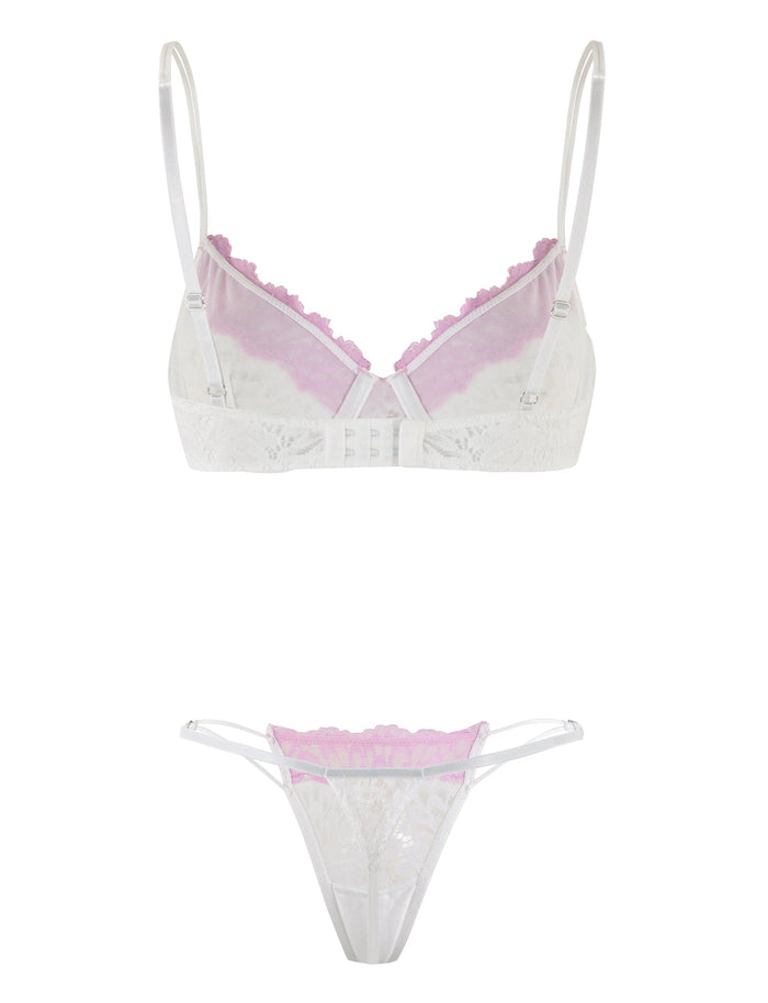 Introducing the DEVYN SET - MULTI in White/Pink by TIGERMIST, a lingerie set featuring a white lace bralette with thin, adjustable shoulder straps and pastel pink trim, paired with a matching white lace thong. The intricate lace patterns and detailed pink trim create an elegant look.