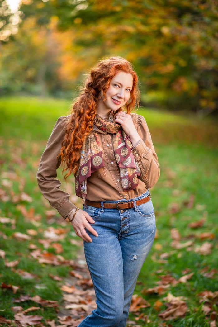 Model wearing Dreamweaver Zodiac Scarf – featuring Alphonse Mucha’s 1896 celestial woman surrounded by zodiac signs and floral scroll artwork – Market of Stars.