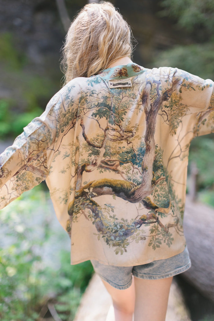 Model wearing Earth and Sky Pixie Duster featuring Charles Aston’s tree art and antique moth illustrations – a soft, nature-inspired layering piece – Market of Stars.