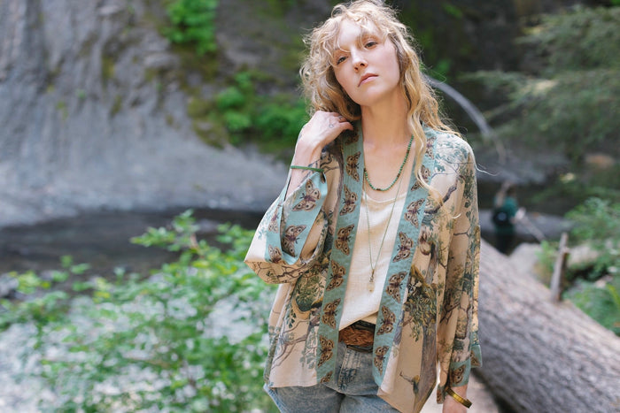 Model wearing Earth and Sky Pixie Duster featuring Charles Aston’s tree art and antique moth illustrations – a soft, nature-inspired layering piece – Market of Stars.