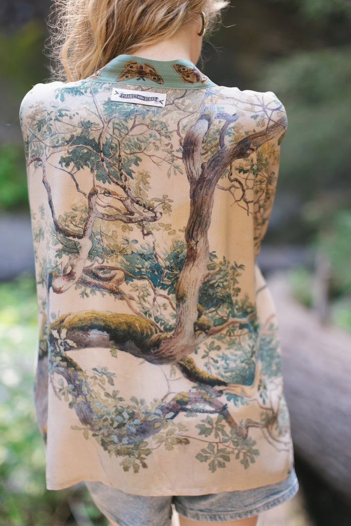 Model wearing Earth and Sky Pixie Duster featuring Charles Aston’s tree art and antique moth illustrations – a soft, nature-inspired layering piece – Market of Stars.