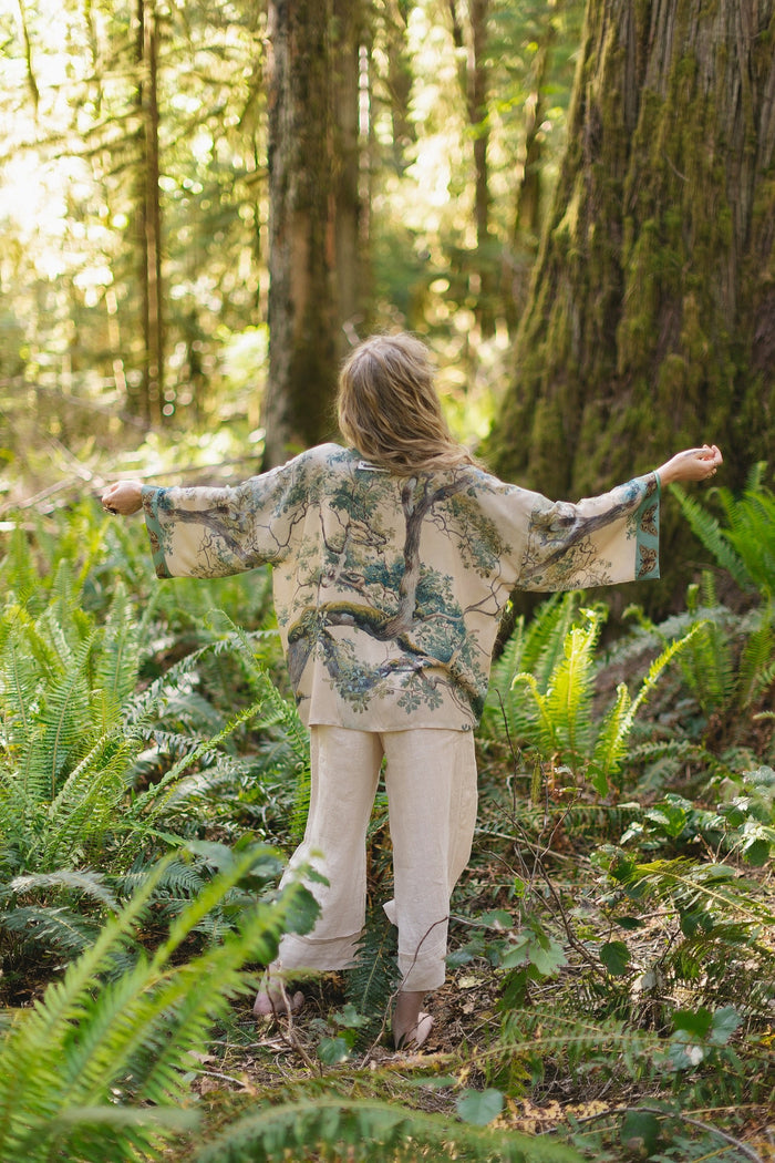 Model wearing Earth and Sky Pixie Duster featuring Charles Aston’s tree art and antique moth illustrations – a soft, nature-inspired layering piece – Market of Stars.