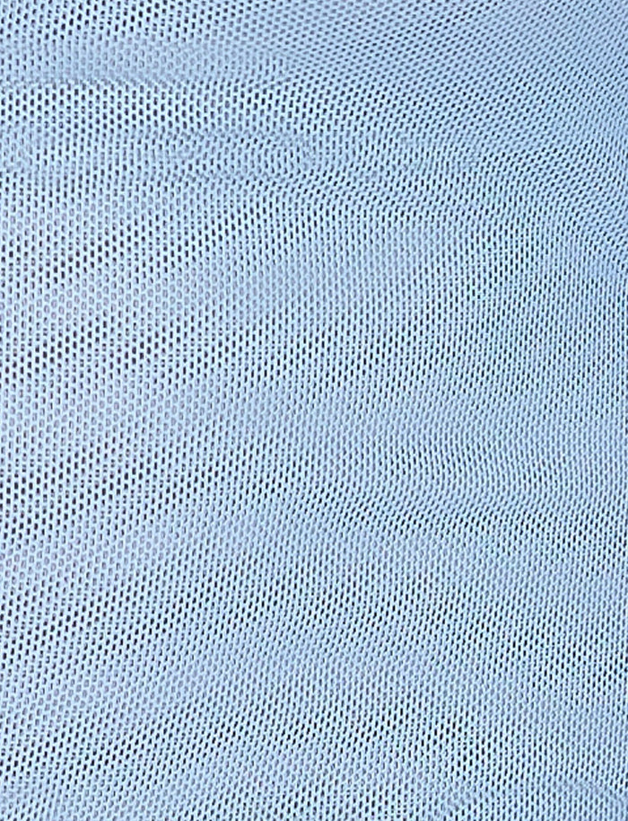 A close-up image of the ELVERA SKIRT - BLUE : GRADIENT FLORAL from TIGERMIST. The material features a textured design with small, evenly spaced holes that create a mesh pattern. The surface has slight undulations, forming gentle waves across the fabric. The overall appearance is uniform and consistent.