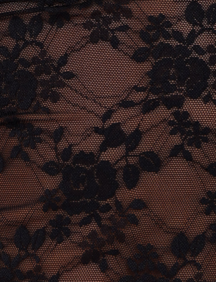 Close-up of intricate black floral lace with a mesh background on the EMERI TOP by TIGERMIST—perfect for highlighting its cut out waist panel and accentuating the bodycon fit.