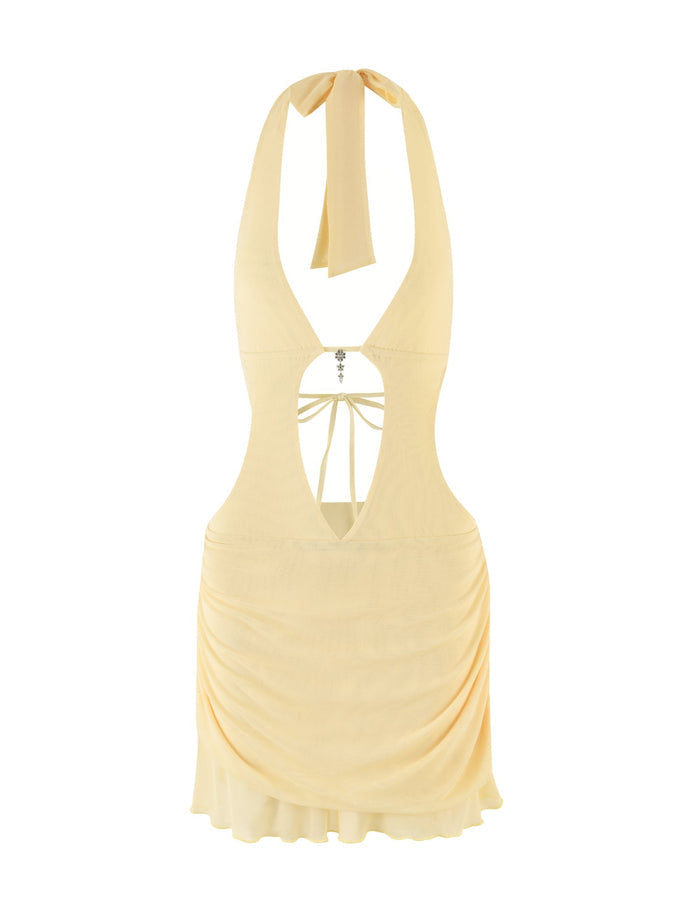 The ESHA MINI DRESS - YELLOW : LEMON by TIGERMIST is a halter-style dress with an open back, featuring a soft draped skirt and a tie closure at the neck. It includes an elegant embellishment connecting the straps at the back, effortlessly blending style and sophistication.