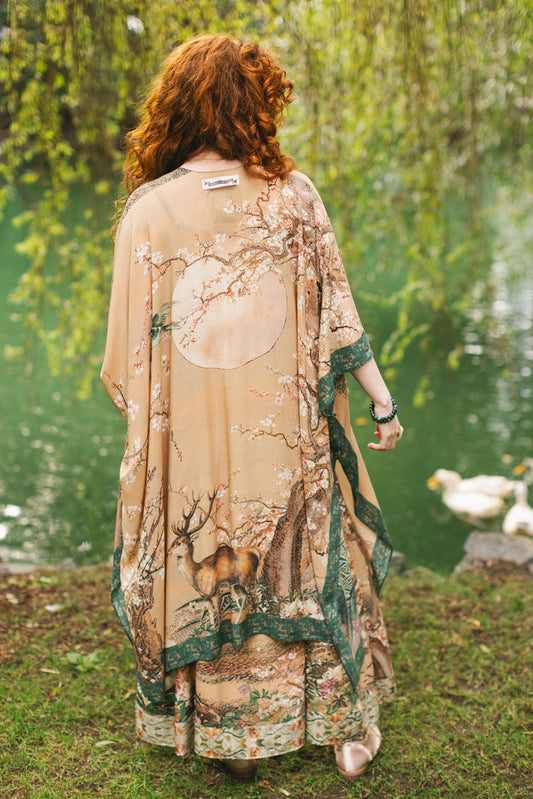 Model wearing Fable Goddess Duster featuring antique Japanese art, cherry and peach blossoms, nightingales, deer, and French block prints - Market of Stars