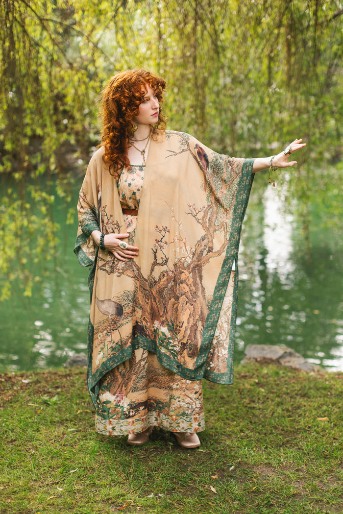Model wearing Fable Goddess Duster featuring antique Japanese art, cherry and peach blossoms, nightingales, deer, and French block prints - Market of Stars