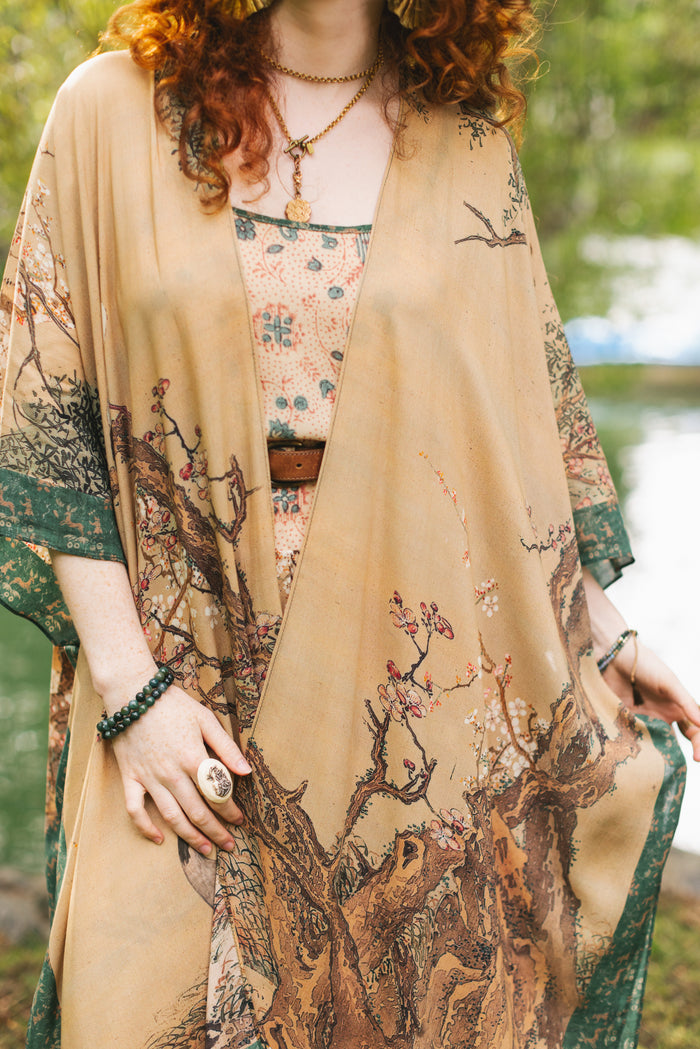 Model wearing Fable Goddess Duster featuring antique Japanese art, cherry and peach blossoms, nightingales, deer, and French block prints - Market of Stars