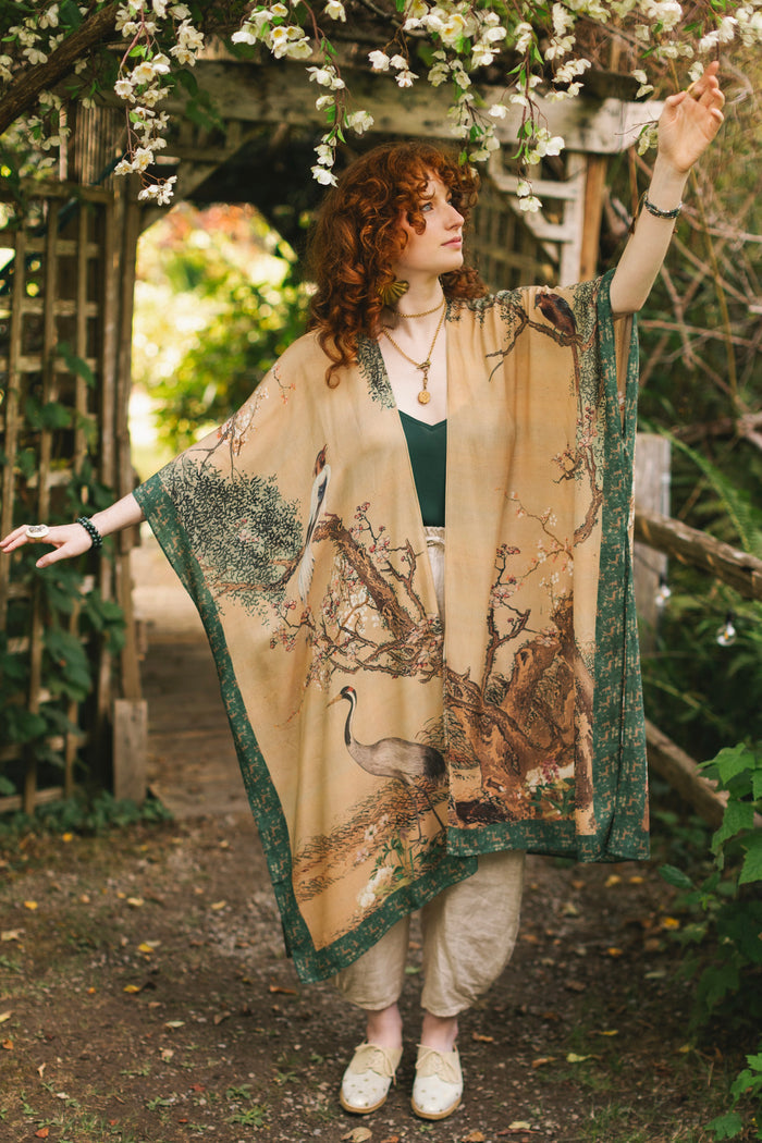 Model wearing Fable Goddess Duster featuring antique Japanese art, cherry and peach blossoms, nightingales, deer, and French block prints - Market of Stars