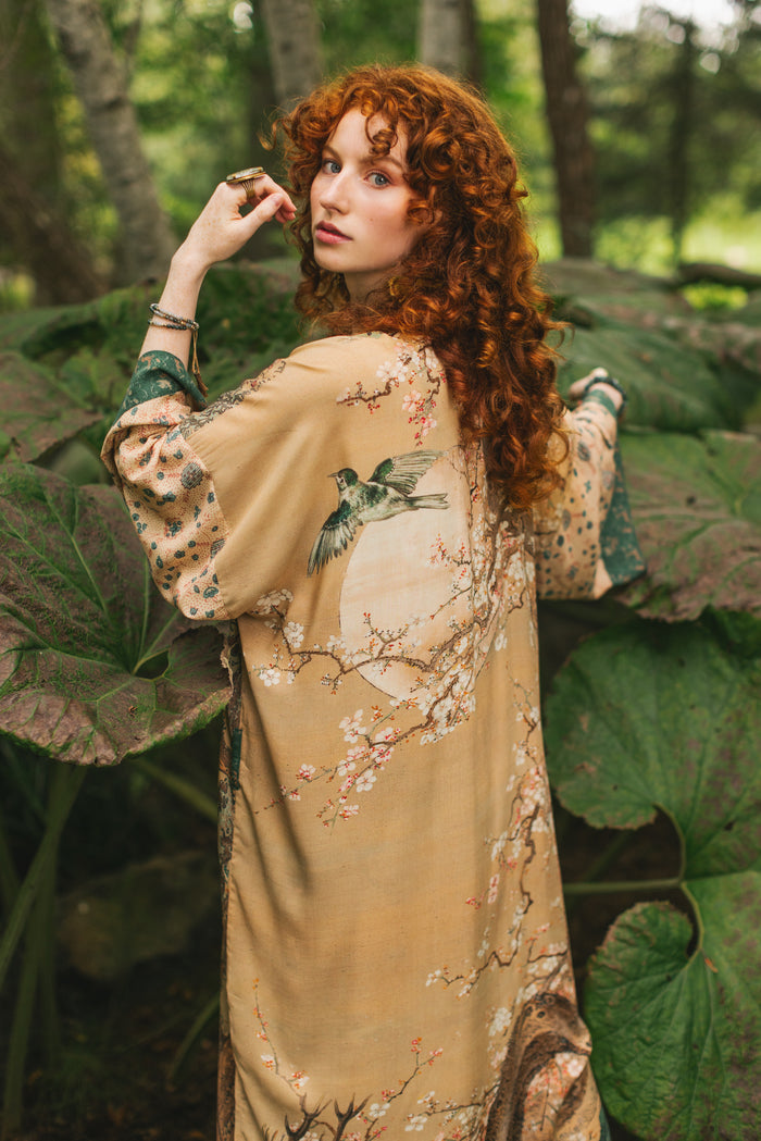 Model wearing Fable Opera Duster featuring antique Japanese art, cherry and peach blossoms, nightingales, deer, and French block prints - Market of Stars