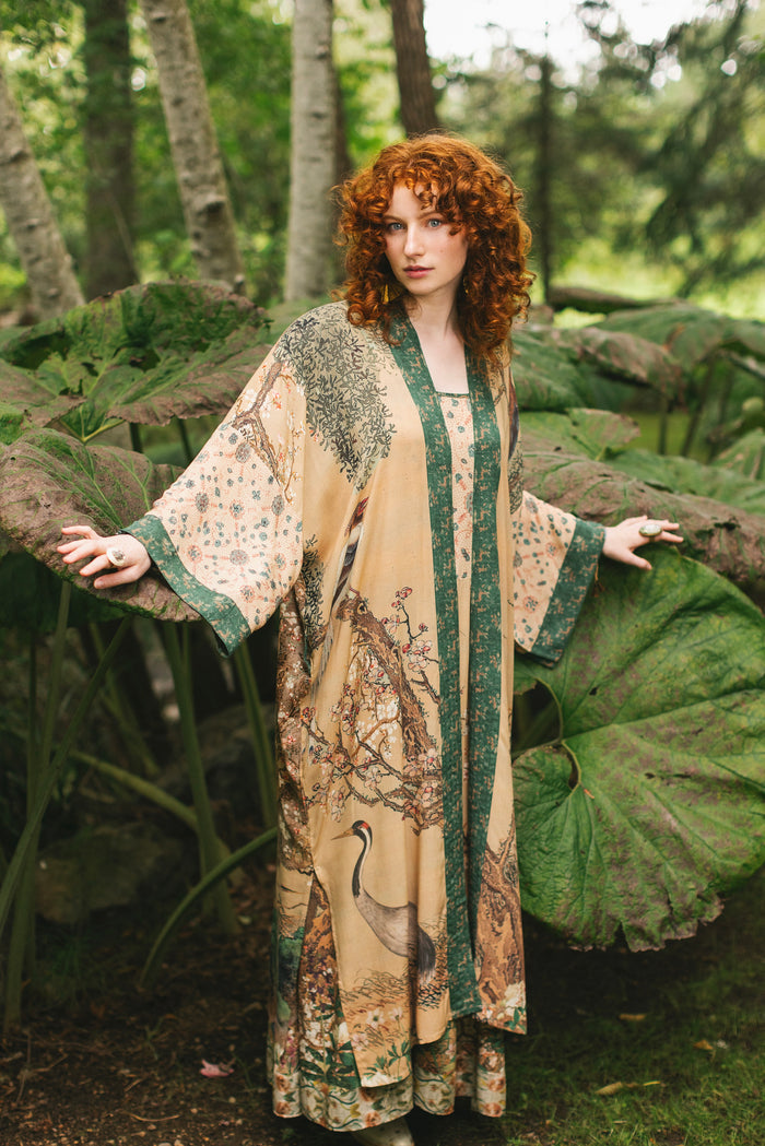 Model wearing Fable Opera Duster featuring antique Japanese art, cherry and peach blossoms, nightingales, deer, and French block prints - Market of Stars