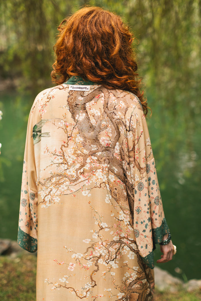Model wearing Fable Opera Duster featuring antique Japanese art, cherry and peach blossoms, nightingales, deer, and French block prints - Market of Stars