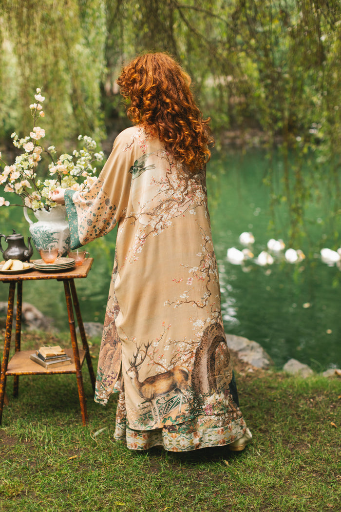 Model wearing Fable Opera Duster featuring antique Japanese art, cherry and peach blossoms, nightingales, deer, and French block prints - Market of Stars
