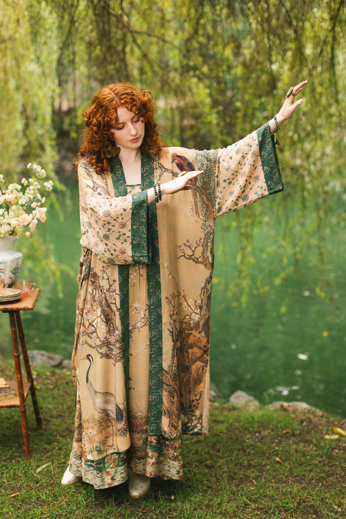 Model wearing Fable Opera Duster featuring antique Japanese art, cherry and peach blossoms, nightingales, deer, and French block prints - Market of Stars