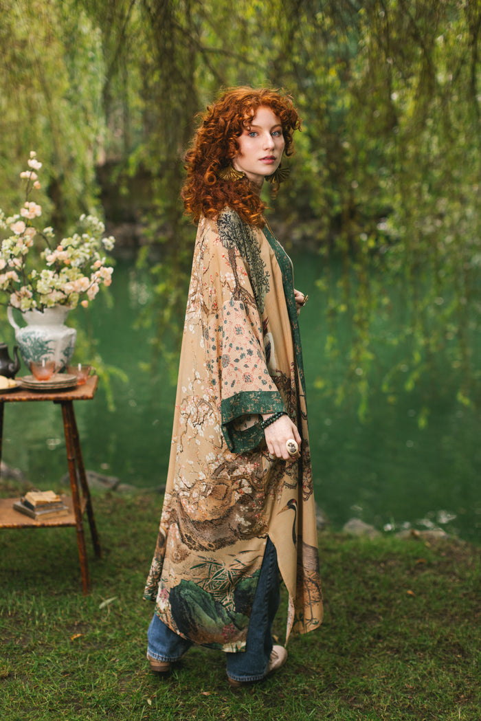 Model wearing Fable Opera Duster featuring antique Japanese art, cherry and peach blossoms, nightingales, deer, and French block prints - Market of Stars