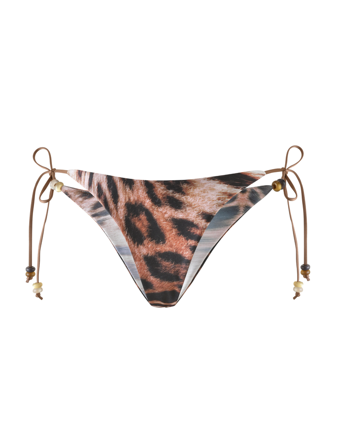 The FINLEA BIKINI BOTTOM by TIGERMIST in Leopard Haze features a cheeky cut and adjustable brown side ties with beads, shown on a white background.