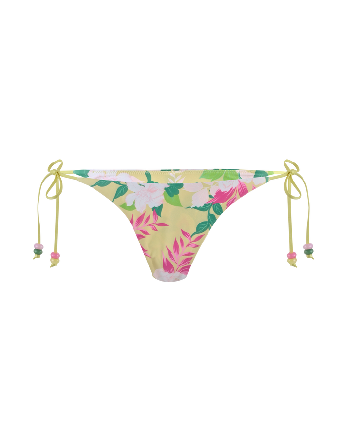 The FINLEA BIKINI BOTTOM - PAISLEY BORDER by TIGERMIST features a cheeky cut, pink and white floral print on yellow elastane fabric, and adjustable side ties finished with yellow bows.