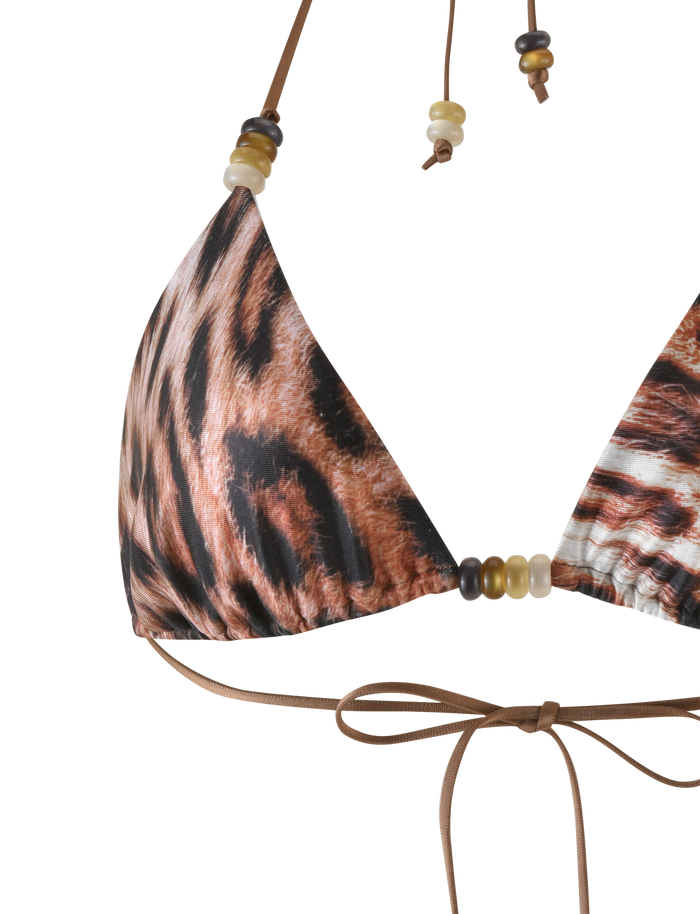 A close-up of the TIGERMIST FINLEA BIKINI TOP in Leopard Haze, featuring a halter neck, brown strings, leopard print and decorative beads.