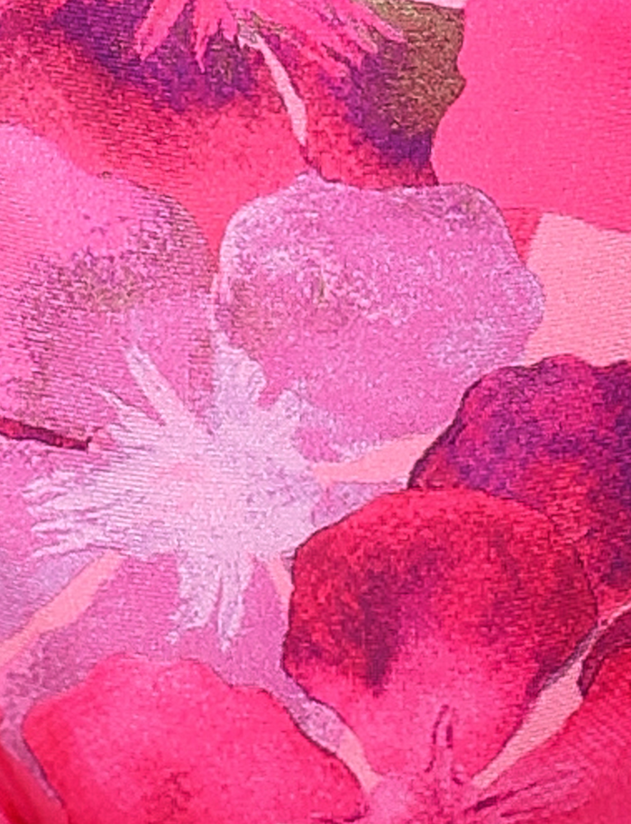 Close-up of the FINLEA BIKINI TOP - PINK : HIBISCUS by TIGERMIST, featuring a pink floral hibiscus print with overlapping flowers and blended edges—perfect for an adjustable bikini style.