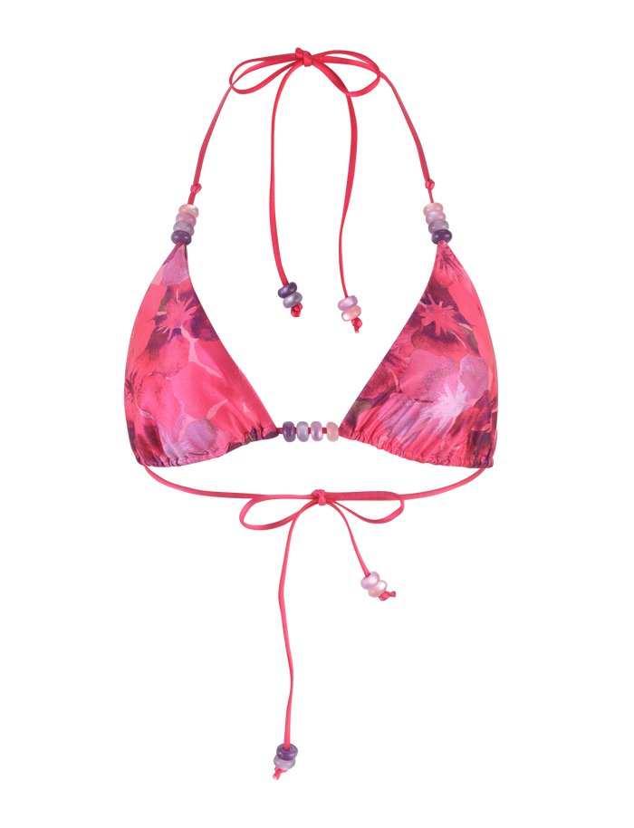 The TIGERMIST FINLEA BIKINI TOP - PINK : HIBISCUS features a pink hibiscus floral print, halter-neck design, adjustable neck and back ties, and small decorative beads for a playful, stylish look.
