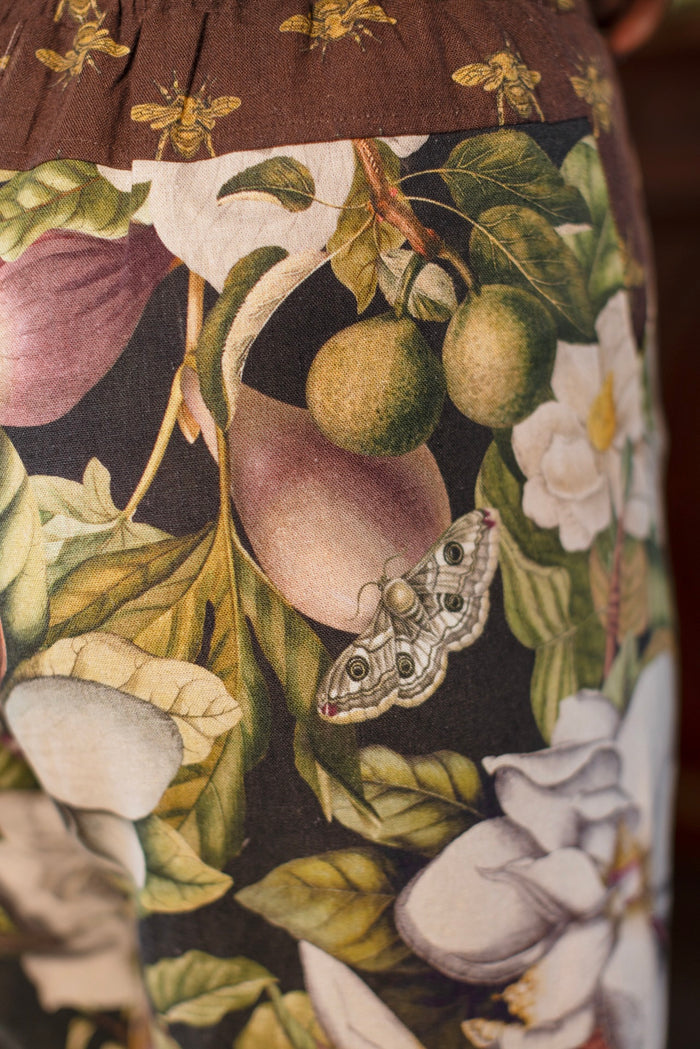 Model wearing Fleur De Lune Artist Pants with lantern-hem silhouette featuring antique magnolia lithographs, delicate moth etchings, and charming bumblebee trim - Market of Stars