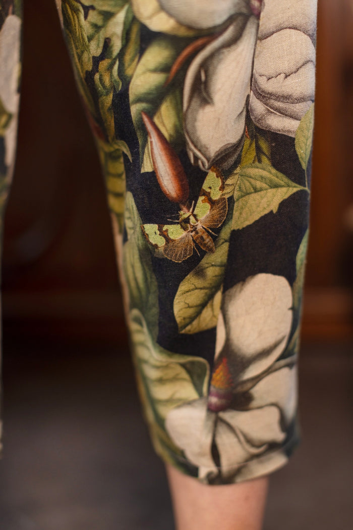 Model wearing Fleur De Lune Artist Pants with lantern-hem silhouette featuring antique magnolia lithographs, delicate moth etchings, and charming bumblebee trim - Market of Stars