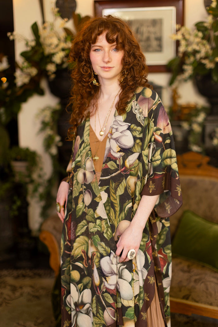 Model wearing a flowy kimono duster featuring vintage magnolia lithographs, delicate moth etchings, and charming bumblebee trim - Market of Stars