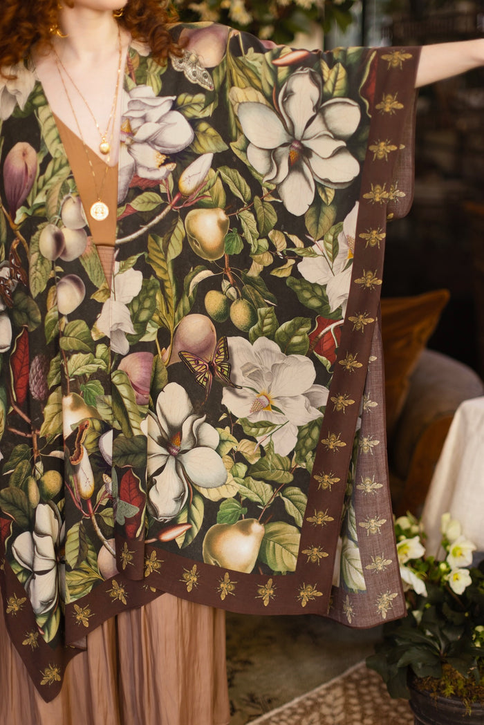 Model wearing a flowy kimono duster featuring vintage magnolia lithographs, delicate moth etchings, and charming bumblebee trim - Market of Stars