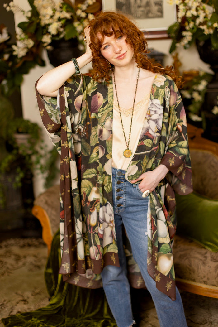 Model wearing a flowy kimono duster featuring vintage magnolia lithographs, delicate moth etchings, and charming bumblebee trim - Market of Stars