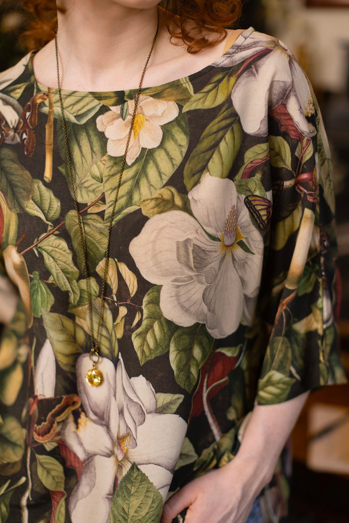 Model wearing the Fleur De Lune Luxe Tee with wide scoop neck and soft bamboo-based viscose, featuring vintage magnolia lithographs, delicate moth etchings, and bumblebee trim - Market of Stars