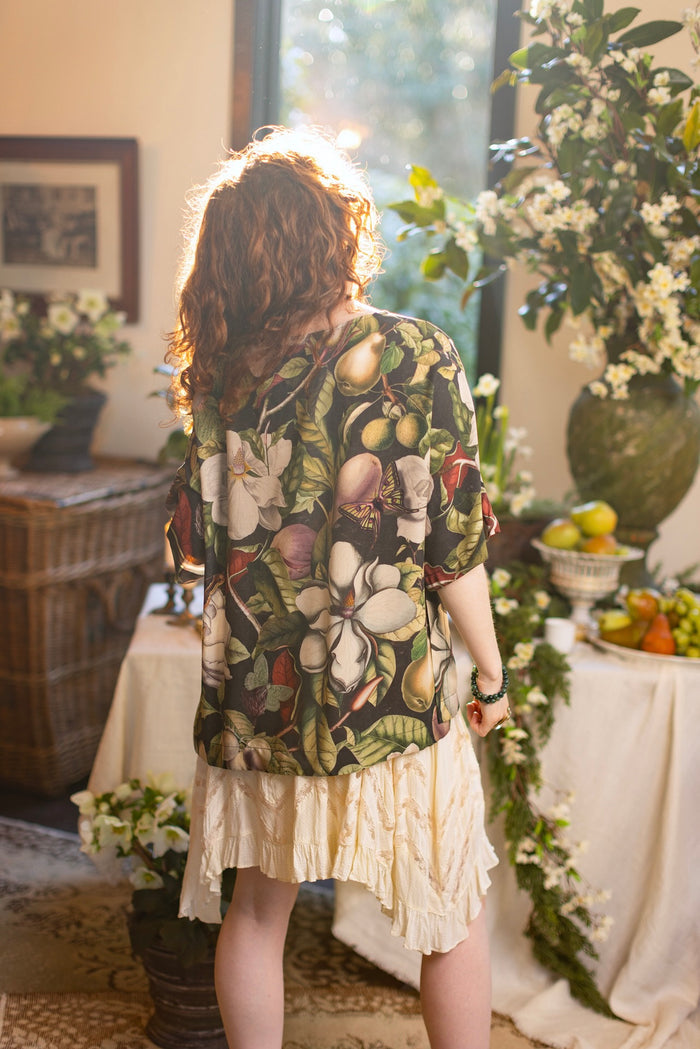Model wearing the Fleur De Lune Luxe Tee with wide scoop neck and soft bamboo-based viscose, featuring vintage magnolia lithographs, delicate moth etchings, and bumblebee trim - Market of Stars
