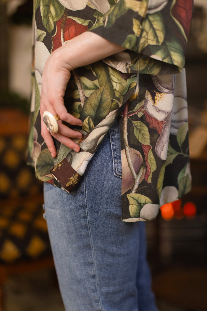 Model wearing the Fleur De Lune Luxe Tee with wide scoop neck and soft bamboo-based viscose, featuring vintage magnolia lithographs, delicate moth etchings, and bumblebee trim - Market of Stars