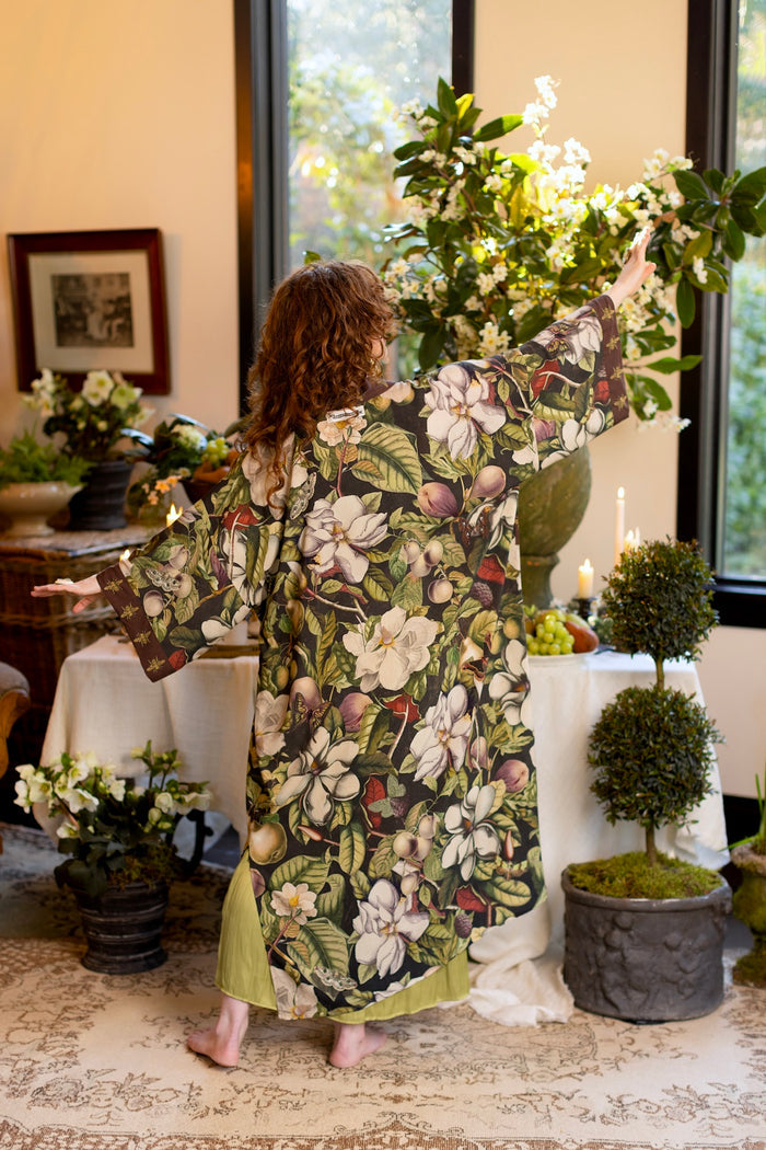 Model wearing a full length kimono duster robe featuring vintage magnolia lithographs, delicate moth etchings, and charming bumblebee trim - Market of Stars