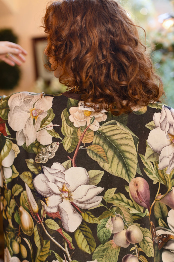 Model wearing a full length kimono duster robe featuring vintage magnolia lithographs, delicate moth etchings, and charming bumblebee trim - Market of Stars