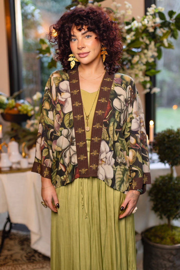 Model wearing a cropped kimono duster featuring vintage magnolia lithographs, delicate moth etchings, and charming bumblebee trim - Market of Stars