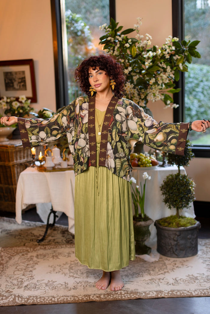 Model wearing a cropped kimono duster featuring vintage magnolia lithographs, delicate moth etchings, and charming bumblebee trim - Market of Stars