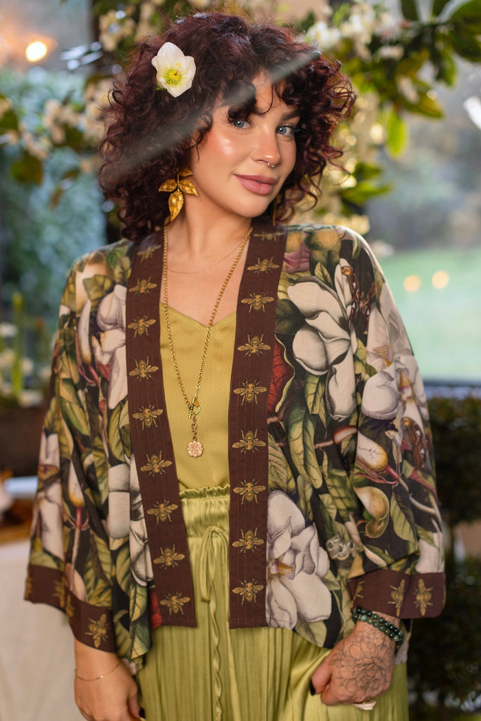 Model wearing a cropped kimono duster featuring vintage magnolia lithographs, delicate moth etchings, and charming bumblebee trim - Market of Stars