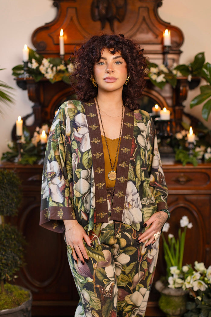 Model wearing a cropped kimono duster featuring vintage magnolia lithographs, delicate moth etchings, and charming bumblebee trim - Market of Stars